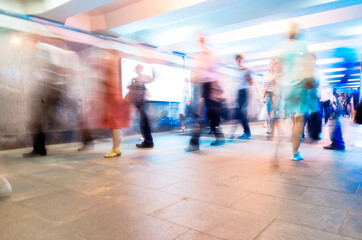 Crowd of People as Pedestrians in Metro, blurred Picture as Background