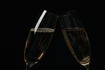 Champagne glasses on black background, close up