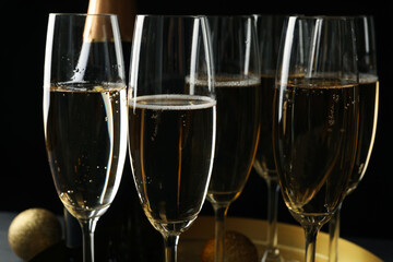 Tray with glasses and bottle of champagne, close up