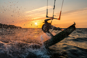Flash photo of kitesurfer in beautiful yellow sunset at the baltic sea - obrazy, fototapety, plakaty