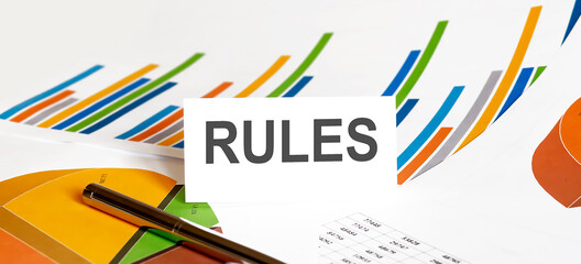 RULES text on paper on chart background with pen