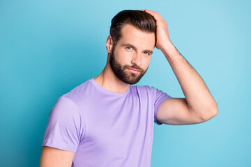 Obraz premium Photo of young handsome man happy enjoy hands touch hair new hairdo wear violet t-shirt isolated over blue color background