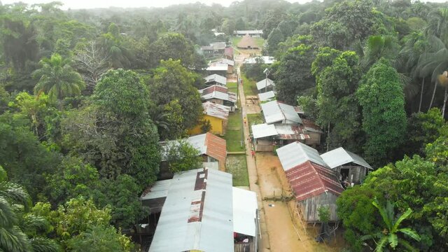 Aerial view of a native tribe houses inside the Amazon, Amazonia Colombia 4K