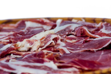 Tasty portions of ham on wooden tray on white background