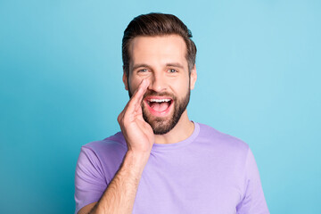 Photo of young man happy positive smile hand touch face announce speak tell news isolated over blue...