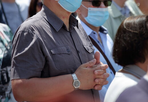 Crowd Of People Wearing Face Protective Masks While Pray Outdoor