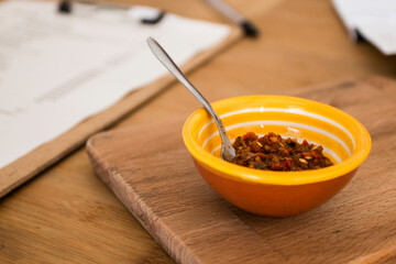 Traditional baked Argentine empanadas savory pastries with meat beef stuffing or vegetables against wooden background and spicy sauce. Latin American fried food