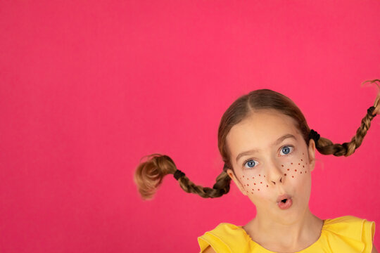 Surprised girl against pink background