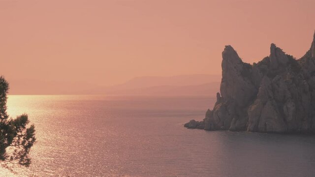 Beautiful seascape with rocky mountains and sea during sunset or sunrise.