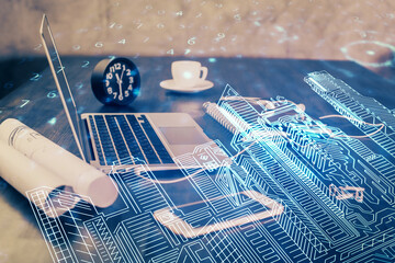 Desktop computer background in office and big town buildings hologram drawing. Double exposure. Smart city concept.