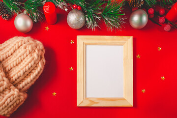 Merry Christmas background. Christmas composition. Christmas frame and white space, rose knitted hat, golden stars, red candles, hands in black gloves and Xmas balls.
