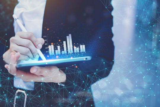 Business woman Are recording data showing business revenue graphs through the laptop as a digital graphic technology. Income Graph Processing Concept