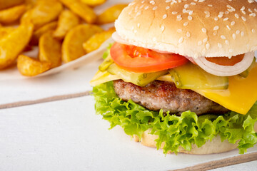Burger with beef, cheese, onion, tomato and lettuce