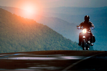 man riding motorcycle on mountain highway