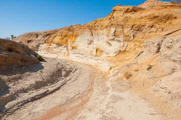 Scenic landscape off road, surrounded by beautiful, yellow color Aktau Mountains in Altyn-Emel National Park, Kazakhstan