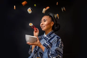Foto auf Acrylglas Japaense Kimono model eating sushi with chopstick © Francois