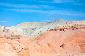 Fototapeta premium Scenic landscape of beautiful, pink color sandstone Aktau Mountains in Altyn Emel National Park on a sunny hot day, Kazakhstan