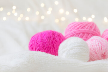 Fototapeta na wymiar Pink knitting balls lie on a light background.