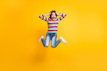 Full length body size photo of jumping high crazy schoolgirl keeping head with hands shouting...