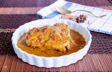 close up of yellow curry with chicken call Gai Gor lae, Thai food from the south of Thailand with herbs ingredient.