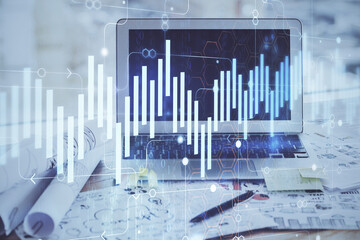 Forex market chart hologram and personal computer background. Double exposure. Concept of investment.