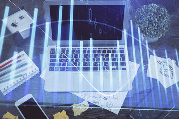 Financial graph colorful drawing and table with computer on background. Double exposure. Concept of...