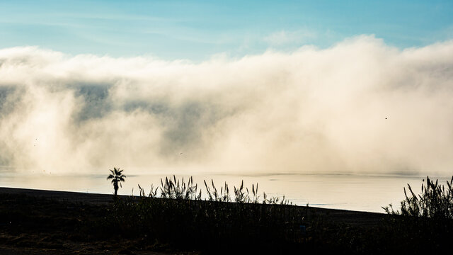 Fog tsunami coming on the beach.