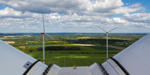 wind turbine, wind farm on a sunny cloudy day shot from eye level, hub height with agricultural...