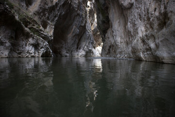 Breathtaking Venetikos river in Portitsa Gorge. Characterized by the high cliffs of 150-200 meters. Picture taken with a small tripod on the surface of the water.