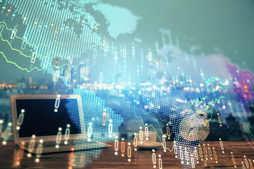 Financial graph colorful drawing and table with computer on background. Multi exposure. Concept of international markets.