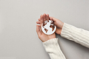A man holds a paper planet Earth in his hands. Earth is our common home, protecting the planet