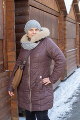 woman in down jacket in winter,woman in a brown down jacket is photographed in the morning at the...