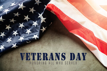Fototapeta na wymiar Veterans day. Honoring all who served. American flag on cement background