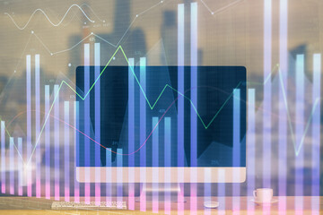 Stock market graph on background with desk and personal computer. Multi exposure. Concept of financial analysis.