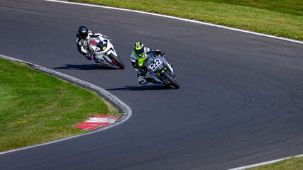A shot of two racing bikes cornering on a track.