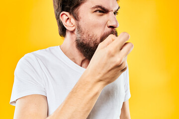 Fototapeta premium bearded man gesturing with hands studio lifestyle discontent yellow background