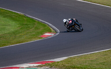 A shot of a racing bike cornering on a track.