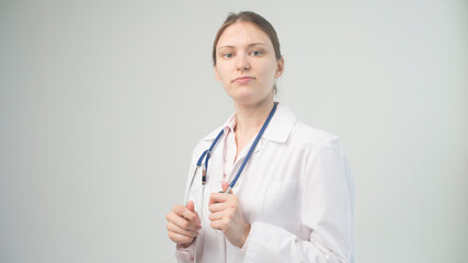 Portrait of an attractive young female doctor in white coat.