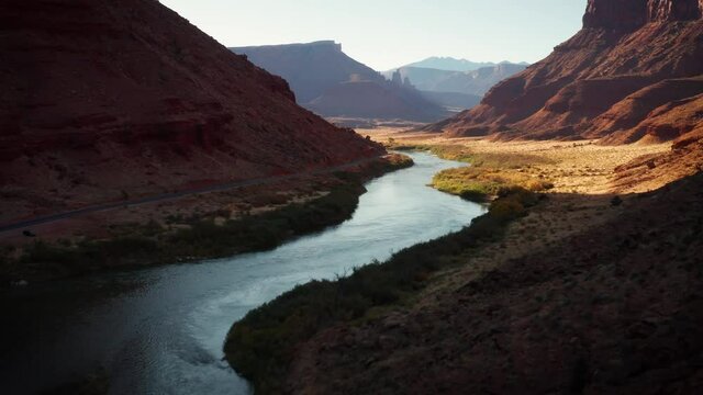 Aerial shot of the Colorado River as is passes thought the rugged and desert landscape of Utah near Moab