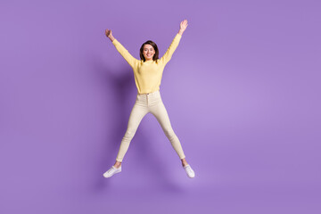 Fototapeta na wymiar Photo portrait full body view of girl spreading arms legs like star jumping up isolated on bright purple colored background
