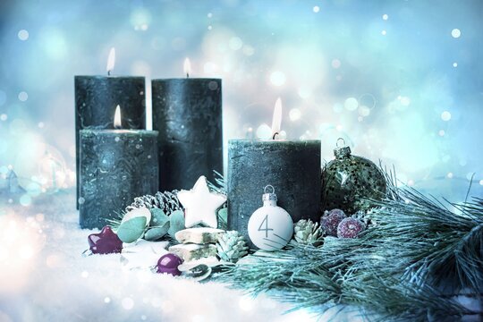 Christmas decoration - Advent candles in the snow - fourth Advent