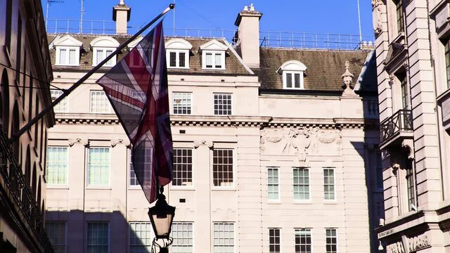 Union Jack fluttering in the wind on a sunny London street