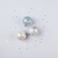Silver confetti and christmas balls on background. Flat lay, top , copy space, holiday background.