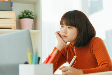 Beautiful young asian thai black short hair woman tired of study from home with laptop.