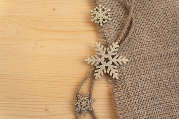 Stylized snowflakes on a wooden surface. Christmas decorations