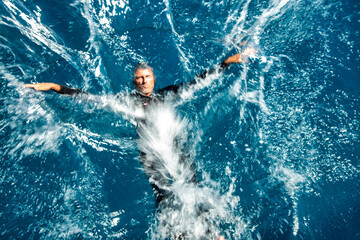 Man splashing in the ocean water, holiday concept, diving in the sea