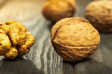 European walnuts on a vintage table. Peeled walnut kernel closeup