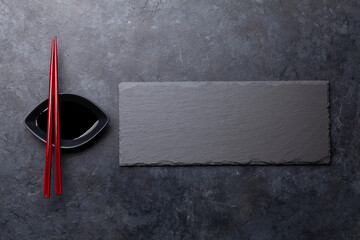 Stone plate and chopsticks for your sushi and maki © evgeeenius