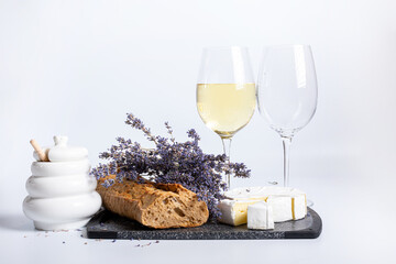 Glasses of white wine and camembert cheese