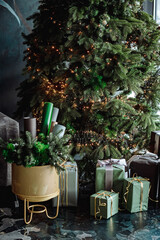 New Year's interior in cold colors. New Year's gifts lie under the tree. Christmas tree near the sofa